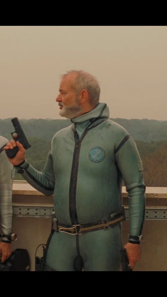 Protect this man at all costs 🐠😂Willem Dafoe wanted in on Wes Anderson’s world so badly he set up a meeting himself, only to find out The Life Aquatic was already fully cast. It didn’t matter. Months later, things shifted and the call came anyway. He said yes instantly. For him, “Wes Anderson was the draw.”What followed wasn’t your typical shoot. Actors took pay cuts just to be there. Life aboard the Belafonte was cramped, fluid, and collaborative, with Dafoe often lingering above deck as scenes were obsessively refined. A role that could’ve taken weeks stretched into five months because the experience itself was the point.On screen, Klaus comes across as outwardly precise but quietly fragile, a balance that makes people unexpectedly protective of him. That in-between space is what drew Dafoe in, and somehow the finished film still carries this same feeling. by @eyeconic.films